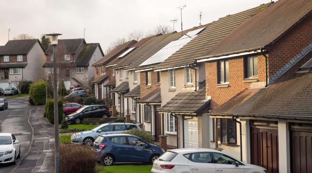 Cars on a driveway on a residential street.