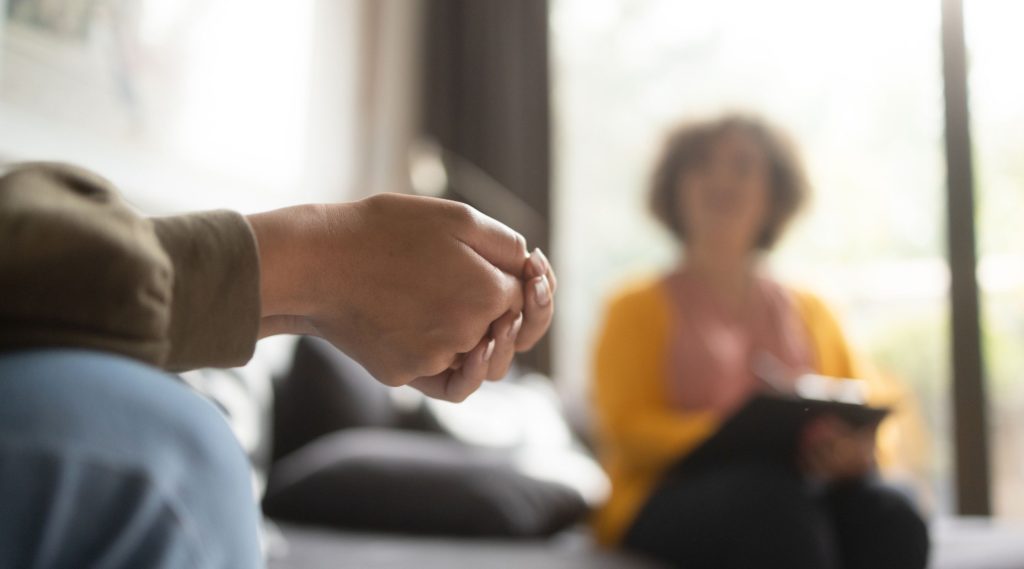 A young woman receiving support from a professional therapist