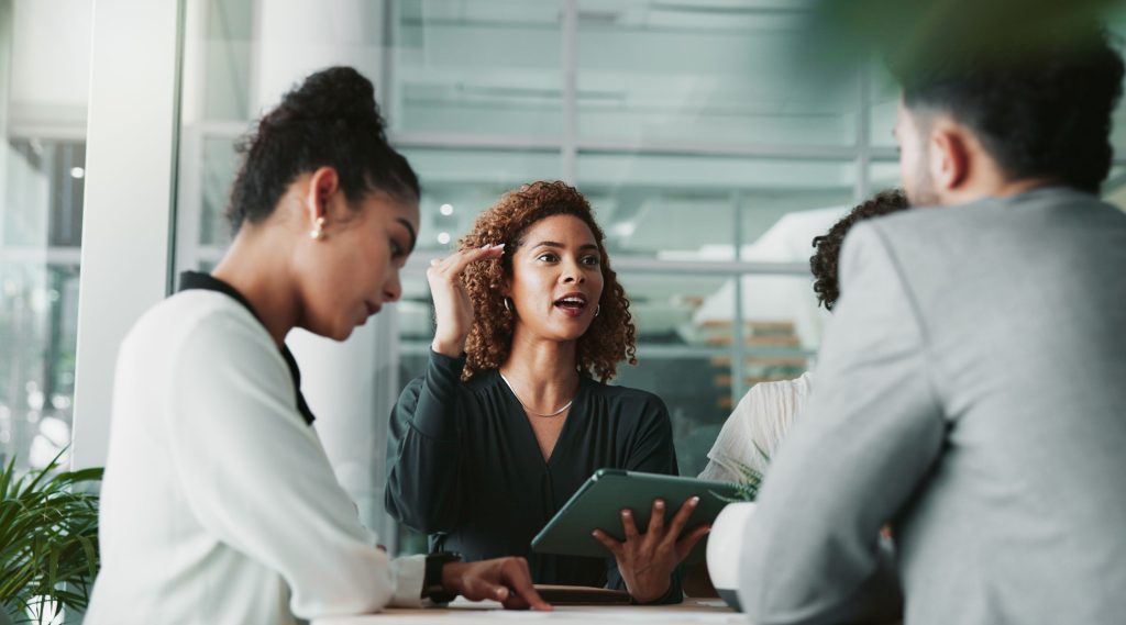 Woman in meeting with another woman and man