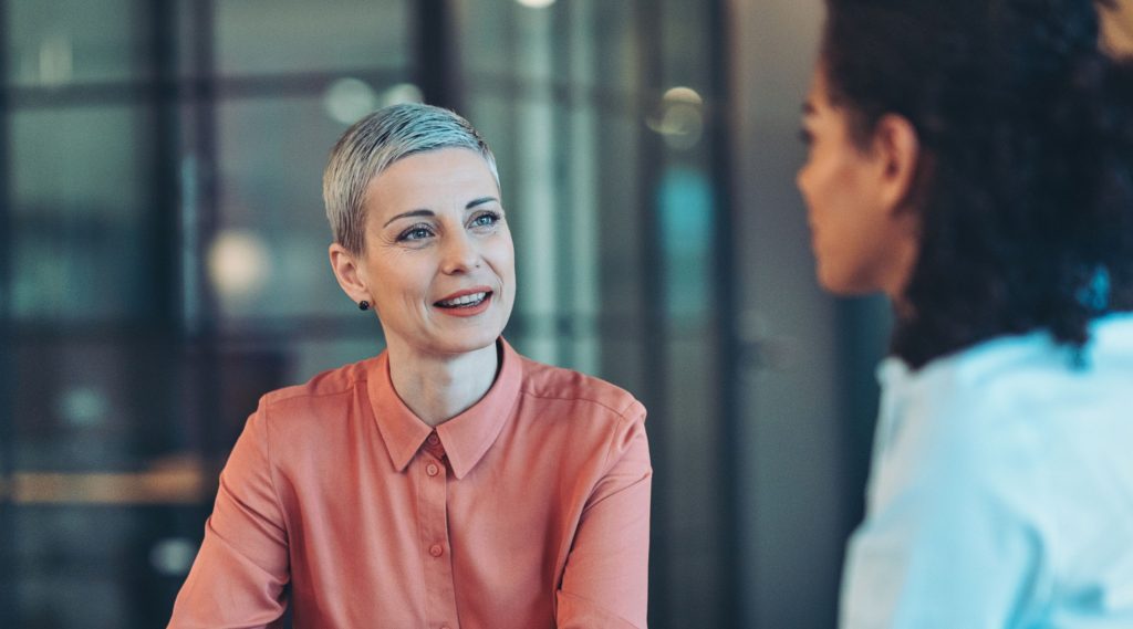 Two business women discussing work